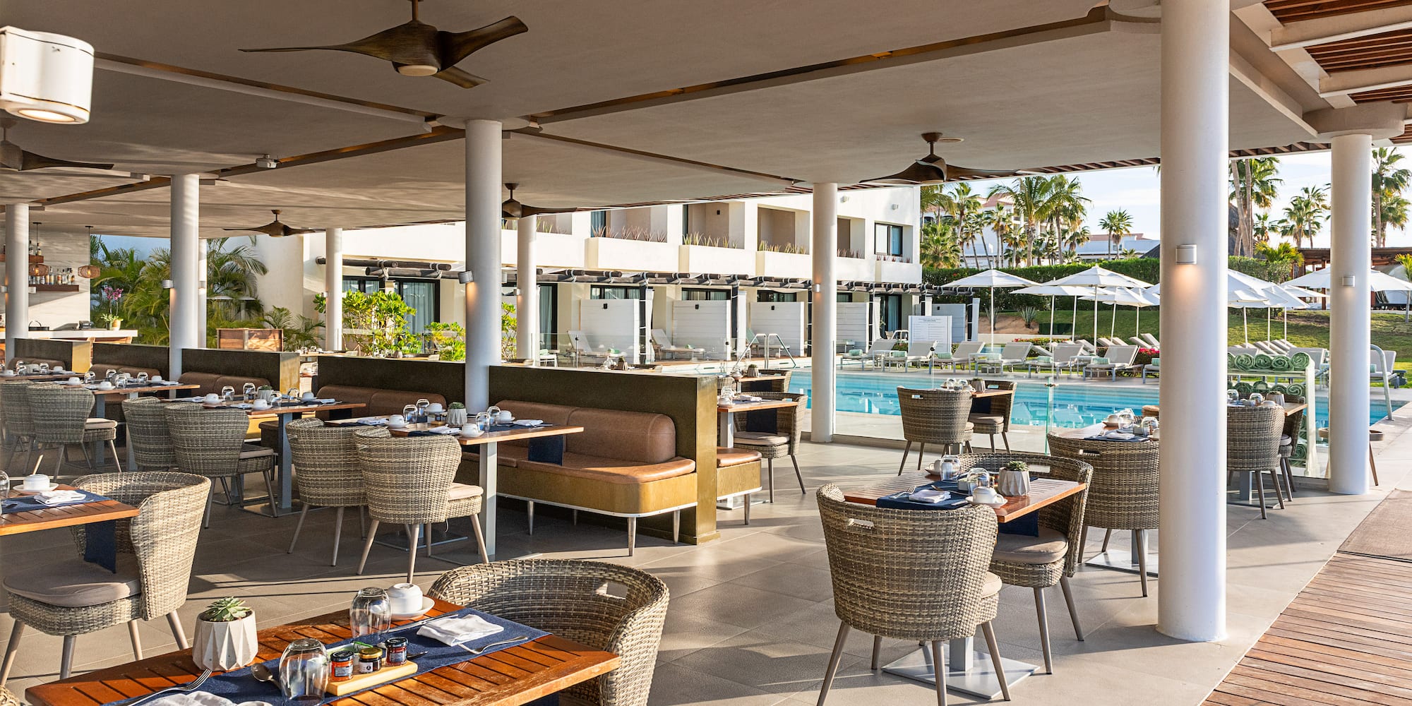 a restaurant with tables and chairs and a pool