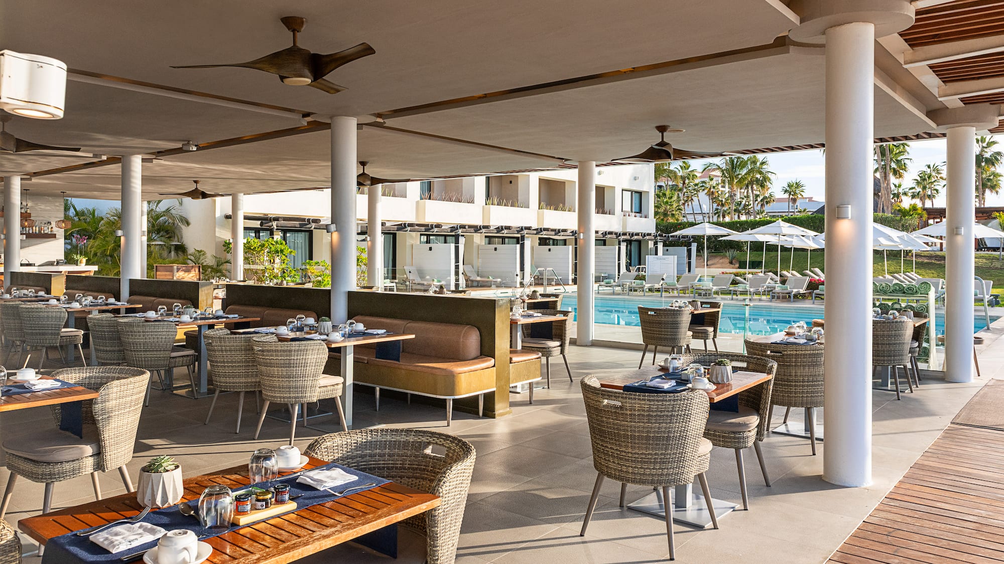 a restaurant with tables and chairs and a pool