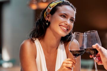 a woman holding wine glasses