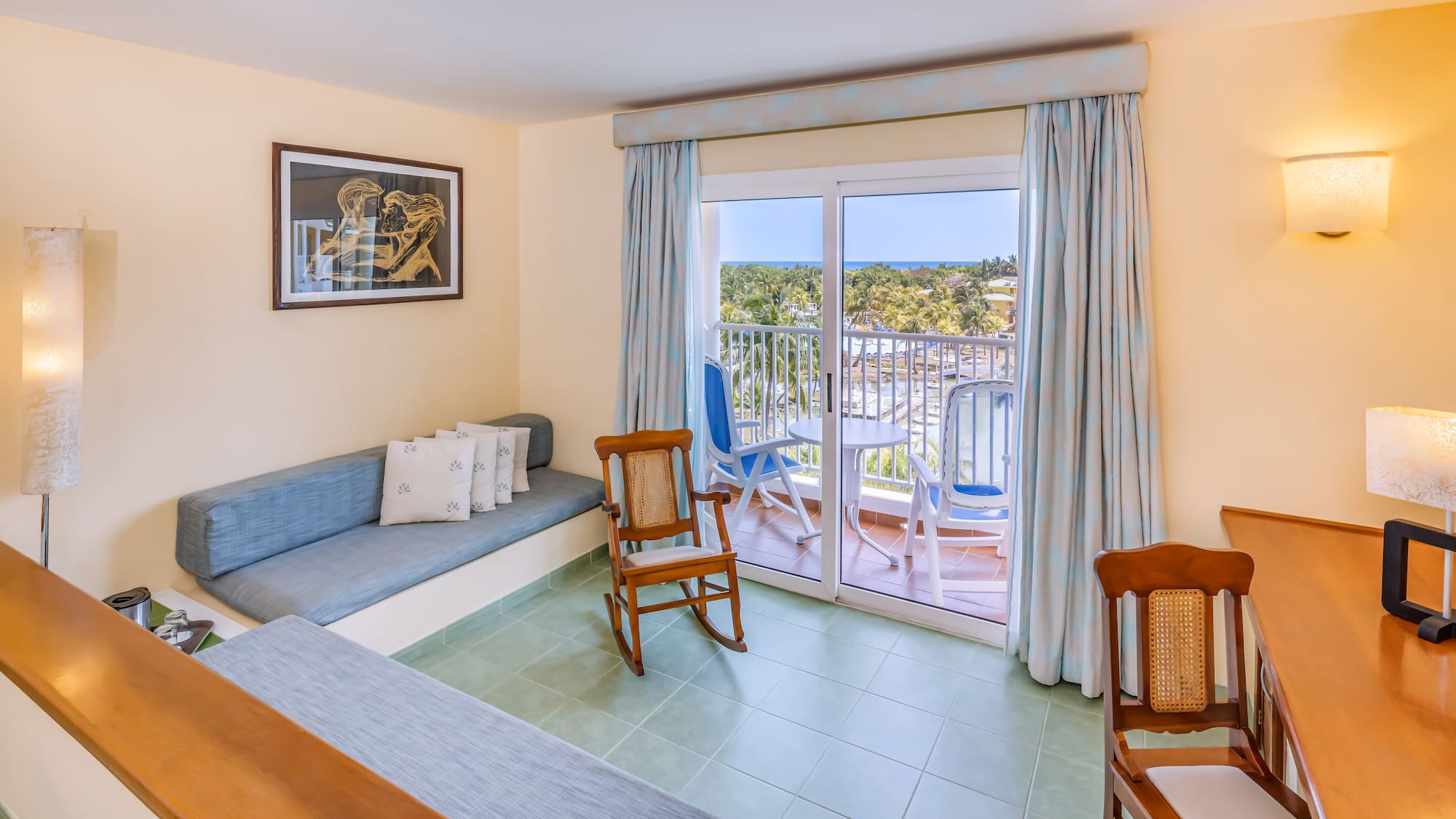 a room with a couch and chairs and a balcony