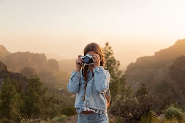 a girl taking a picture with a camera