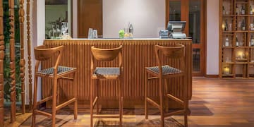 a bar with chairs and a cash register