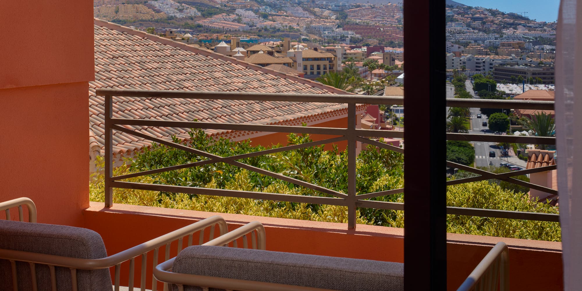 a balcony with a view of a city and mountains