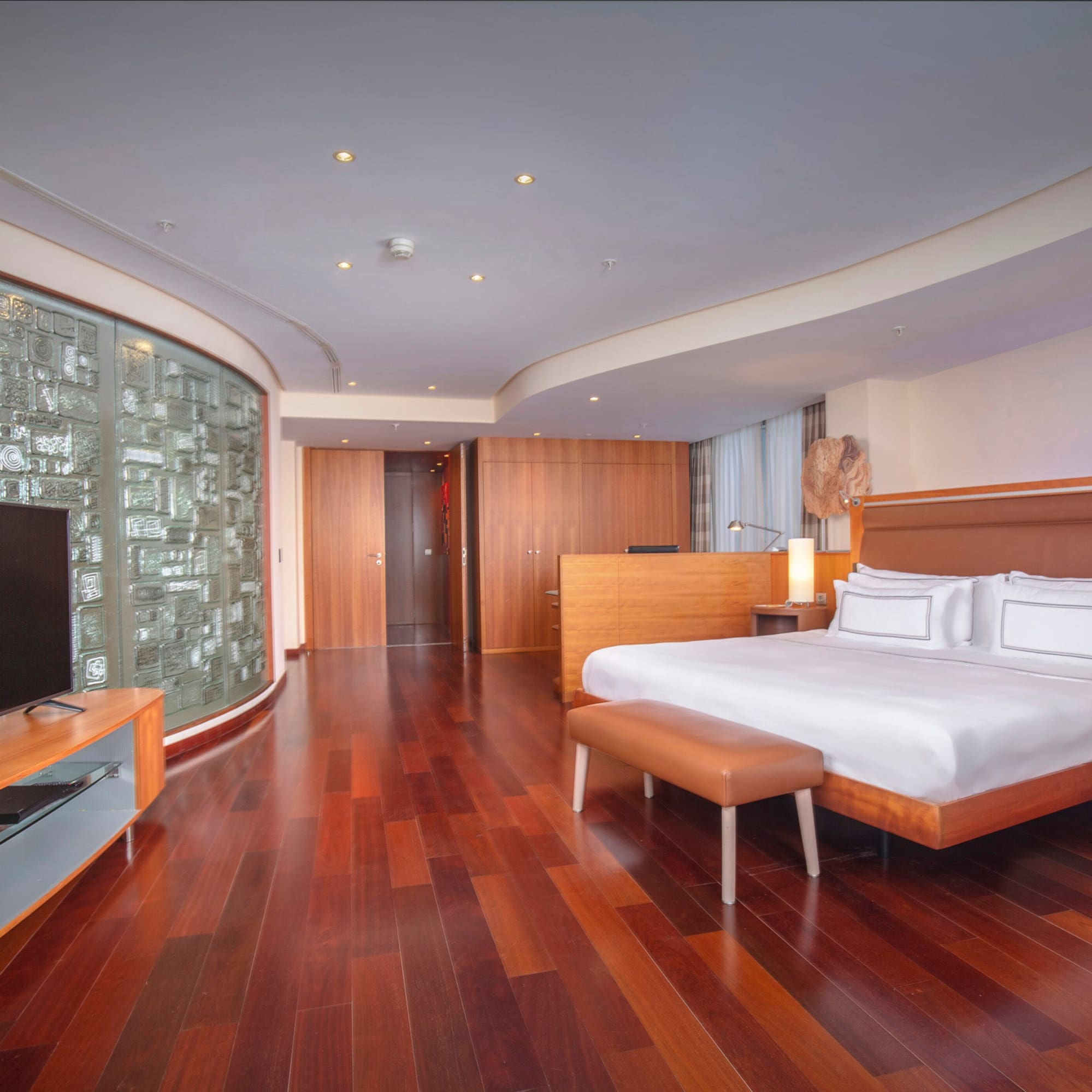 a room with a bed and a television