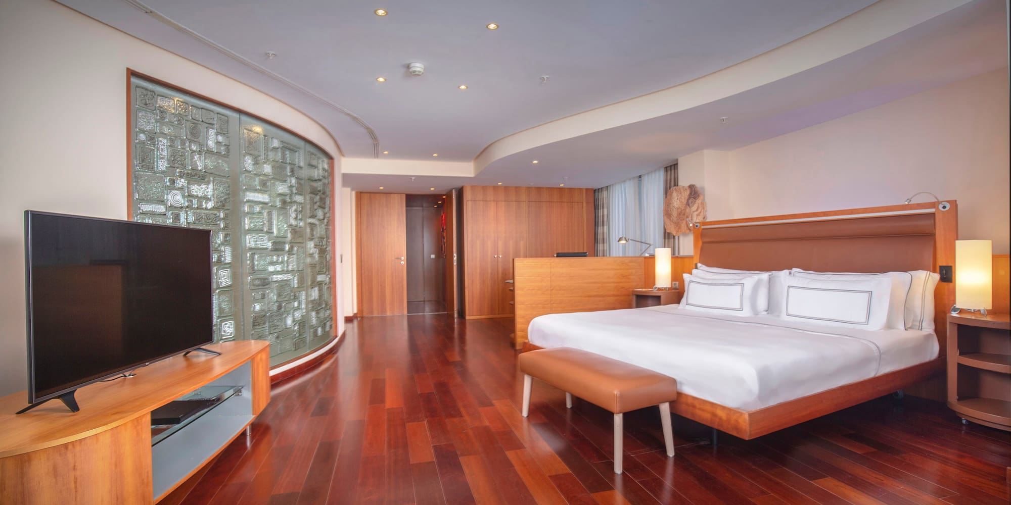 a room with a bed and a television