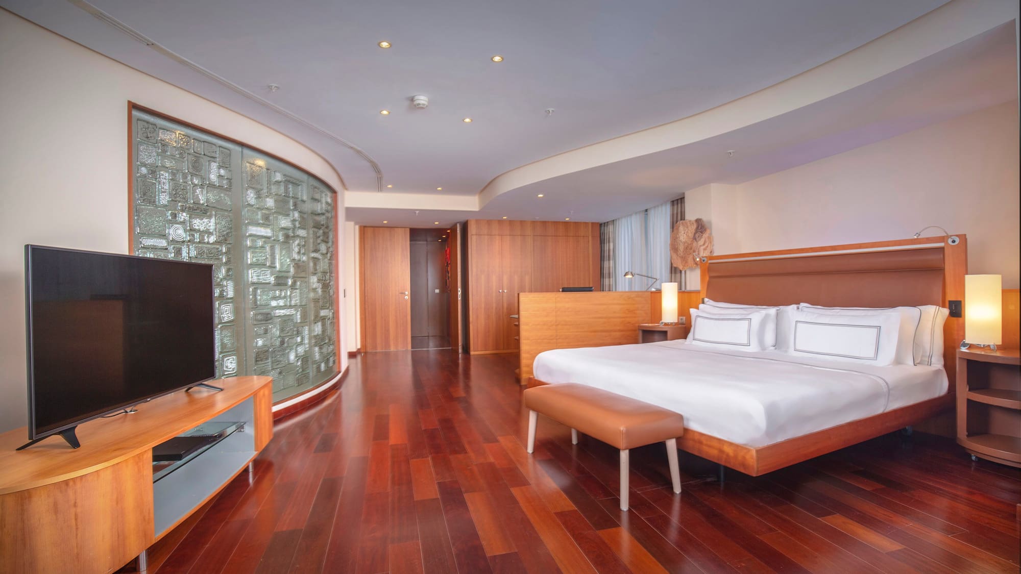 a room with a bed and a television