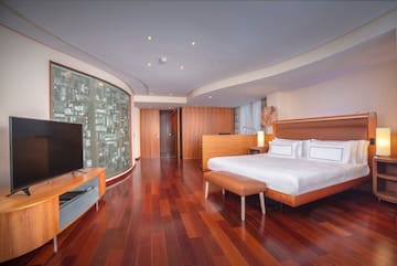a room with a bed and a television