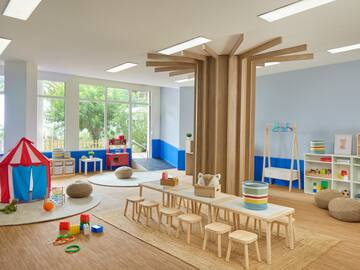a room with a table and chairs and toys