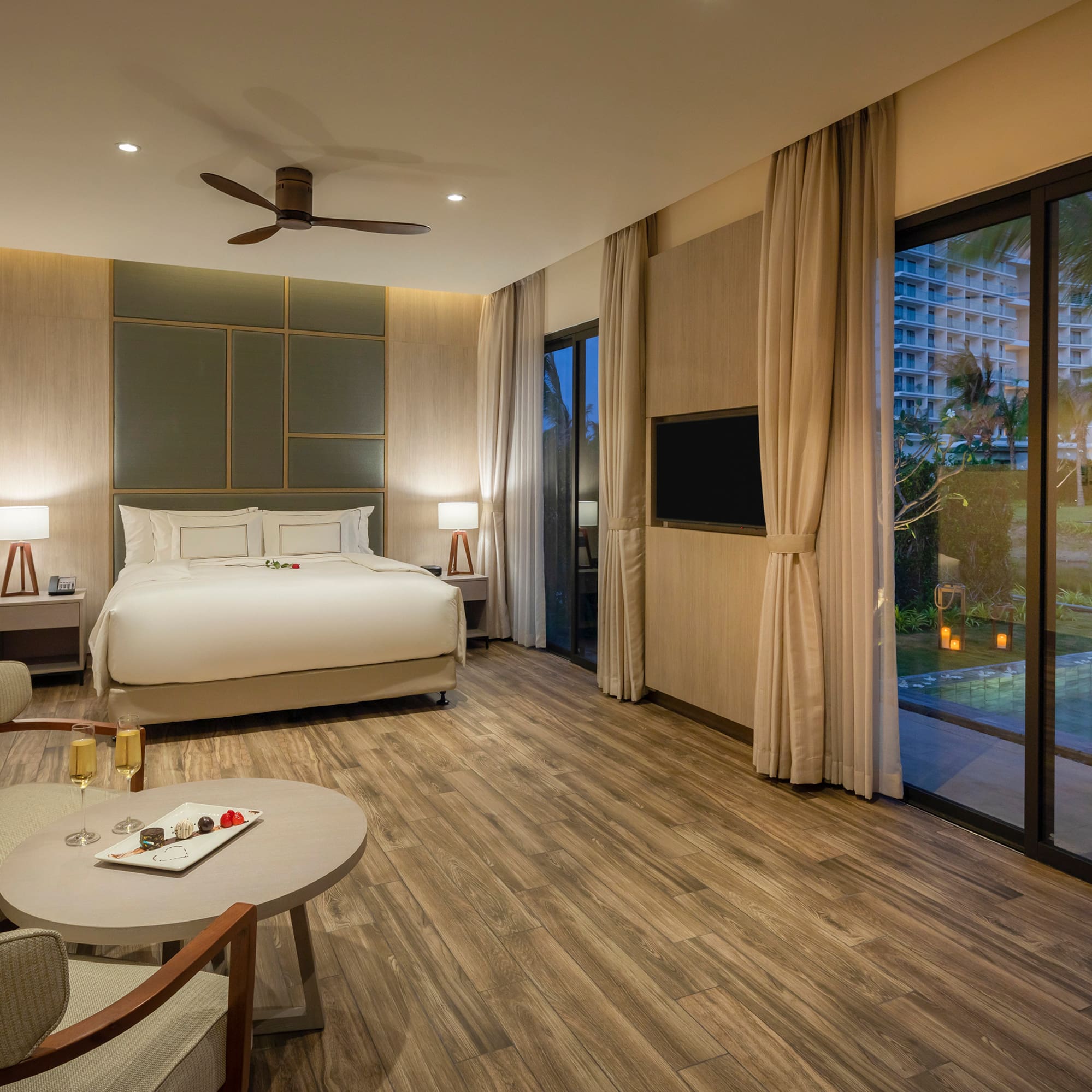 a room with a bed and a pool in the background