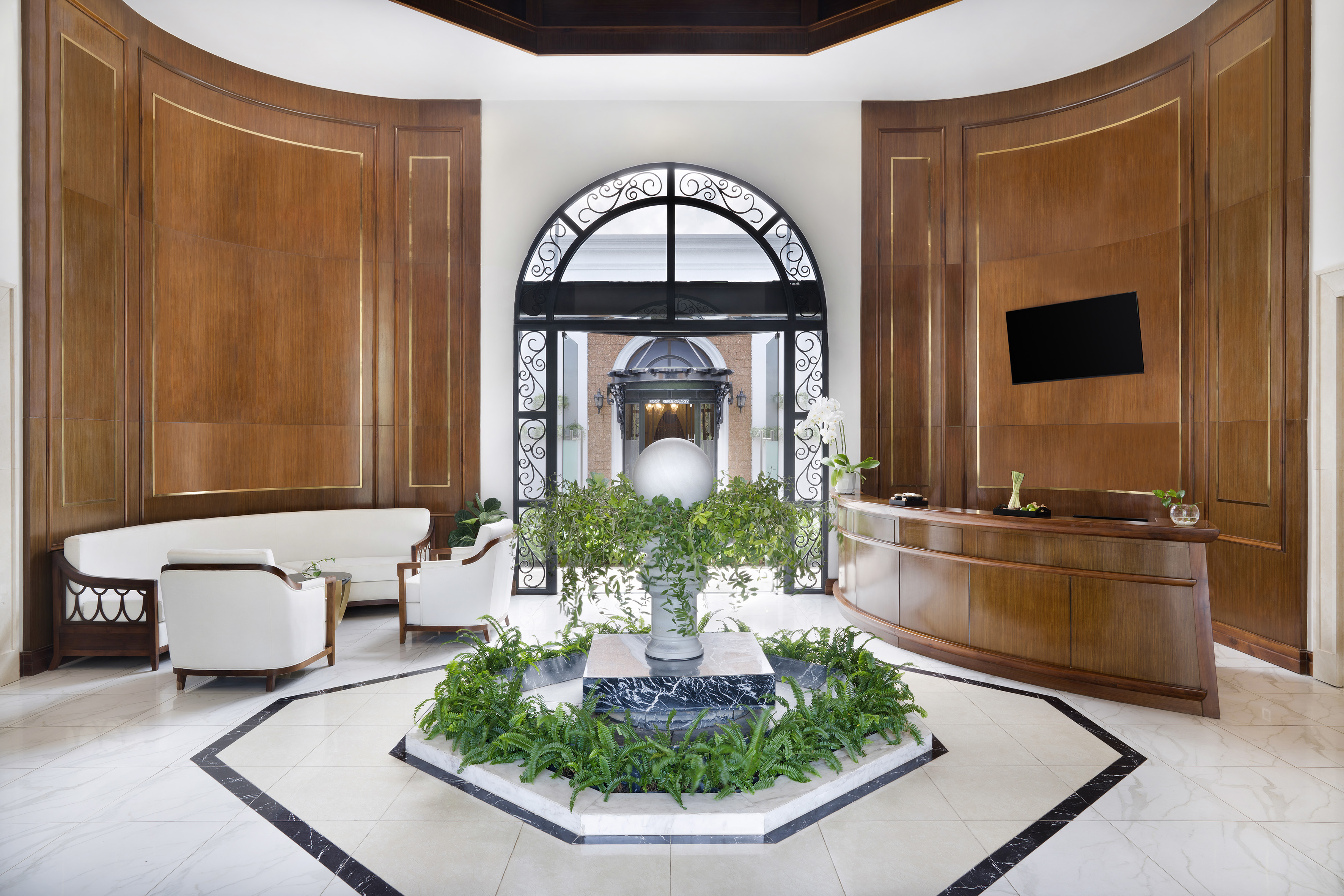 a room with a fountain and chairs