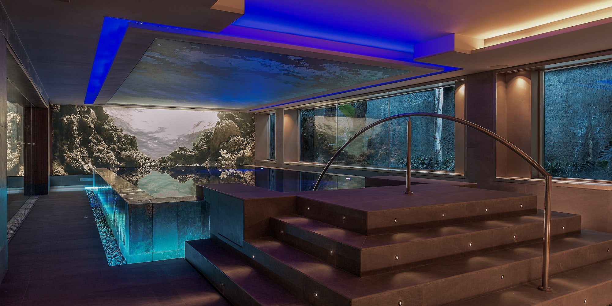 a room with a pool and stairs