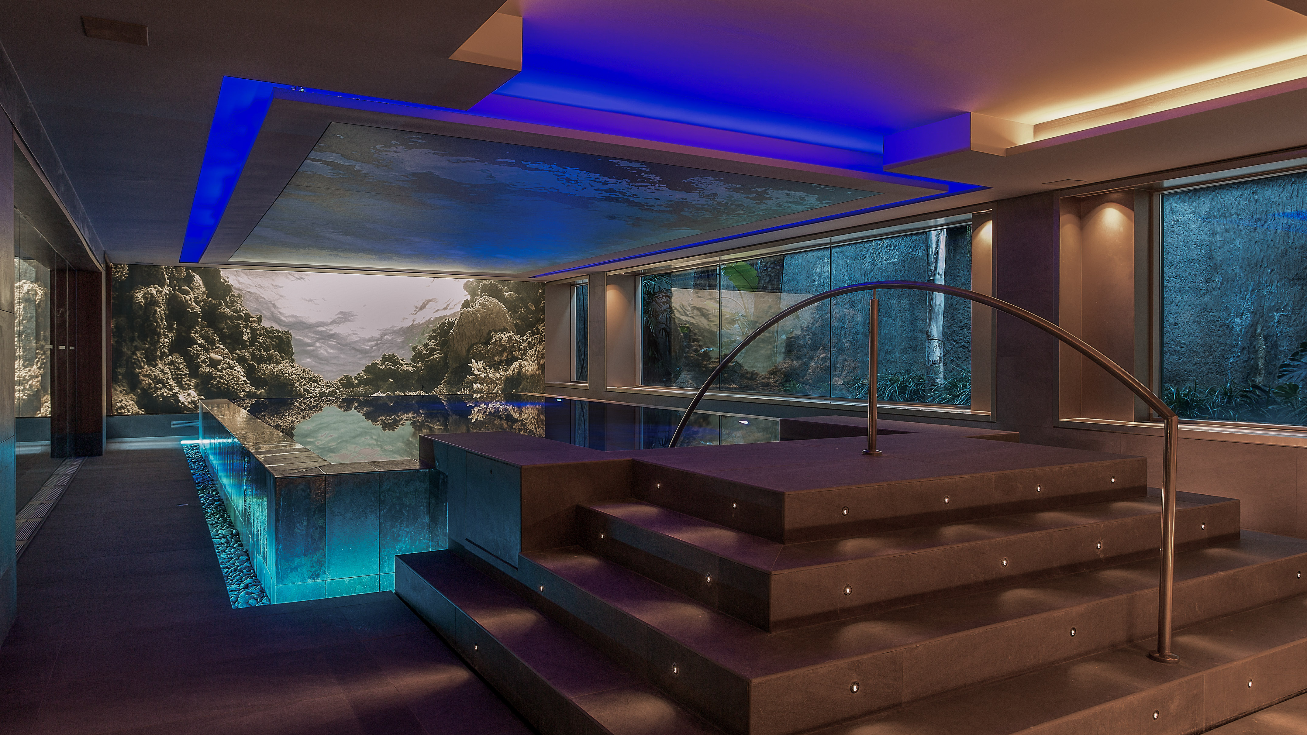 a room with a pool and stairs