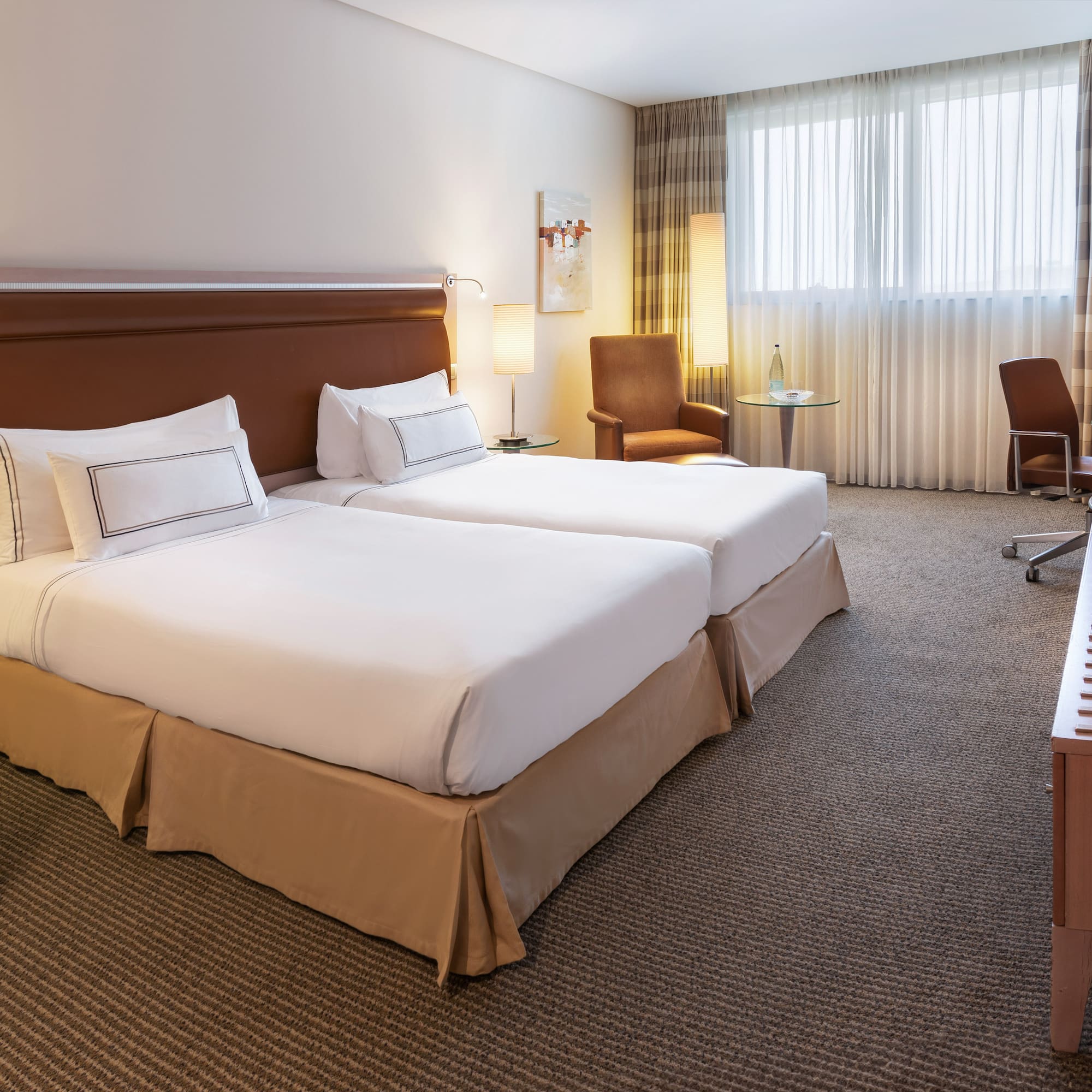 a hotel room with two beds and a desk