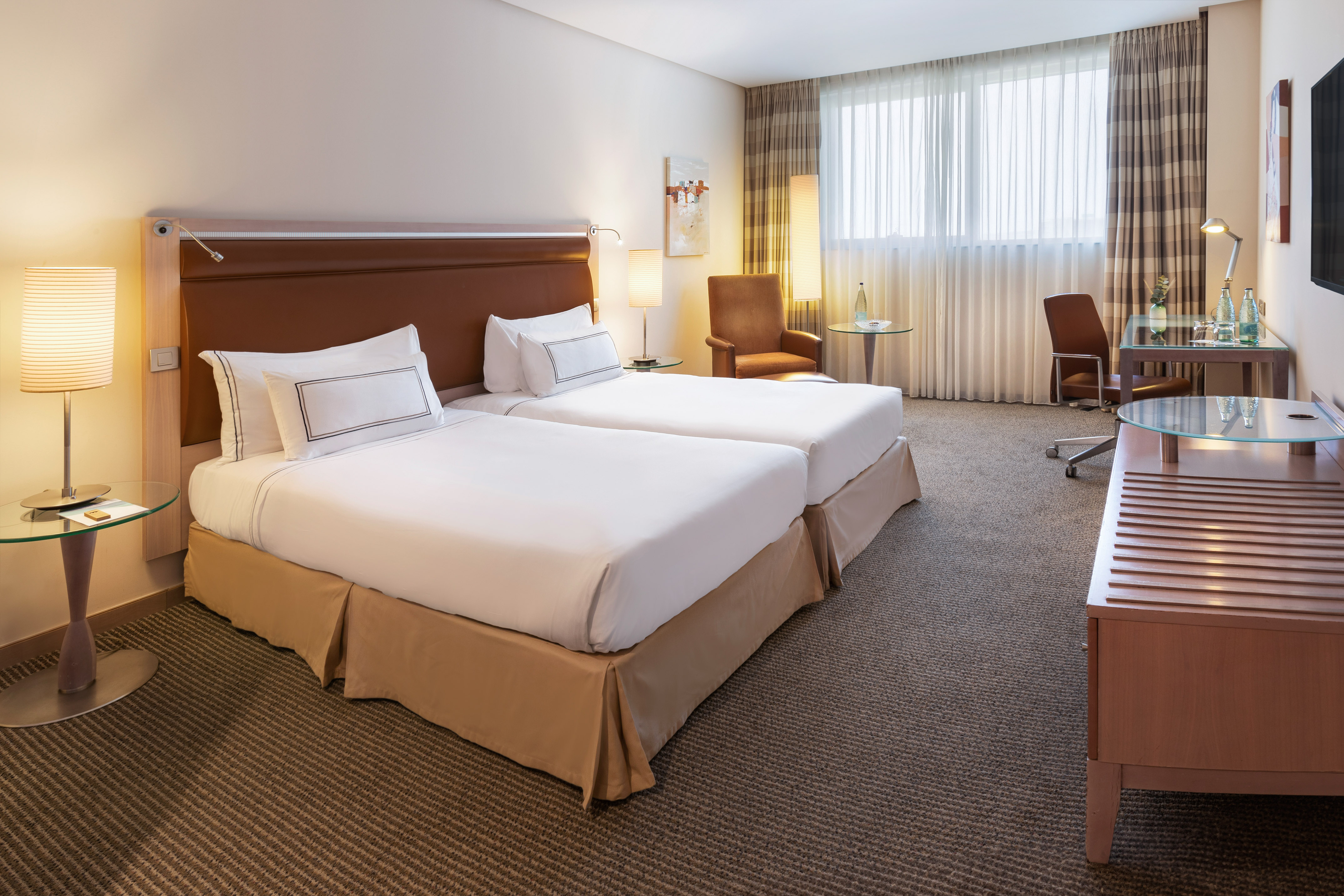 a hotel room with two beds and a desk