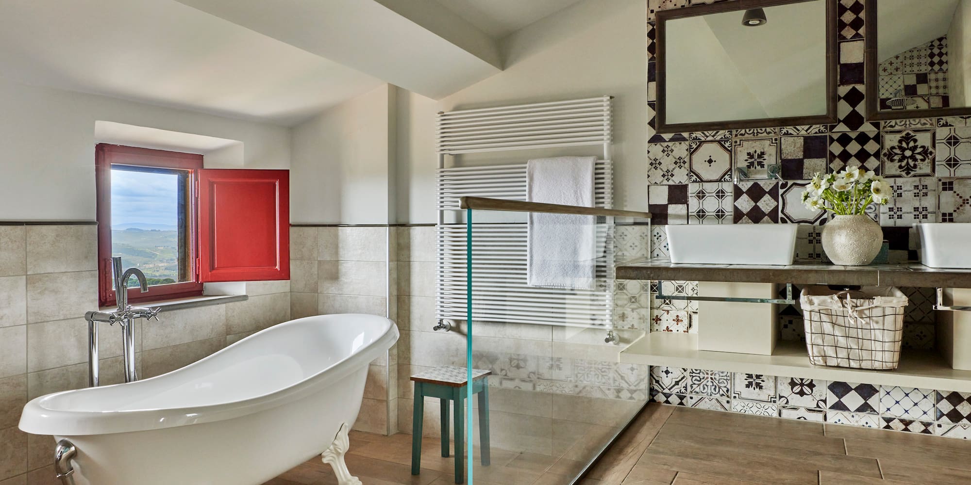 a bathroom with a glass shower and a tub