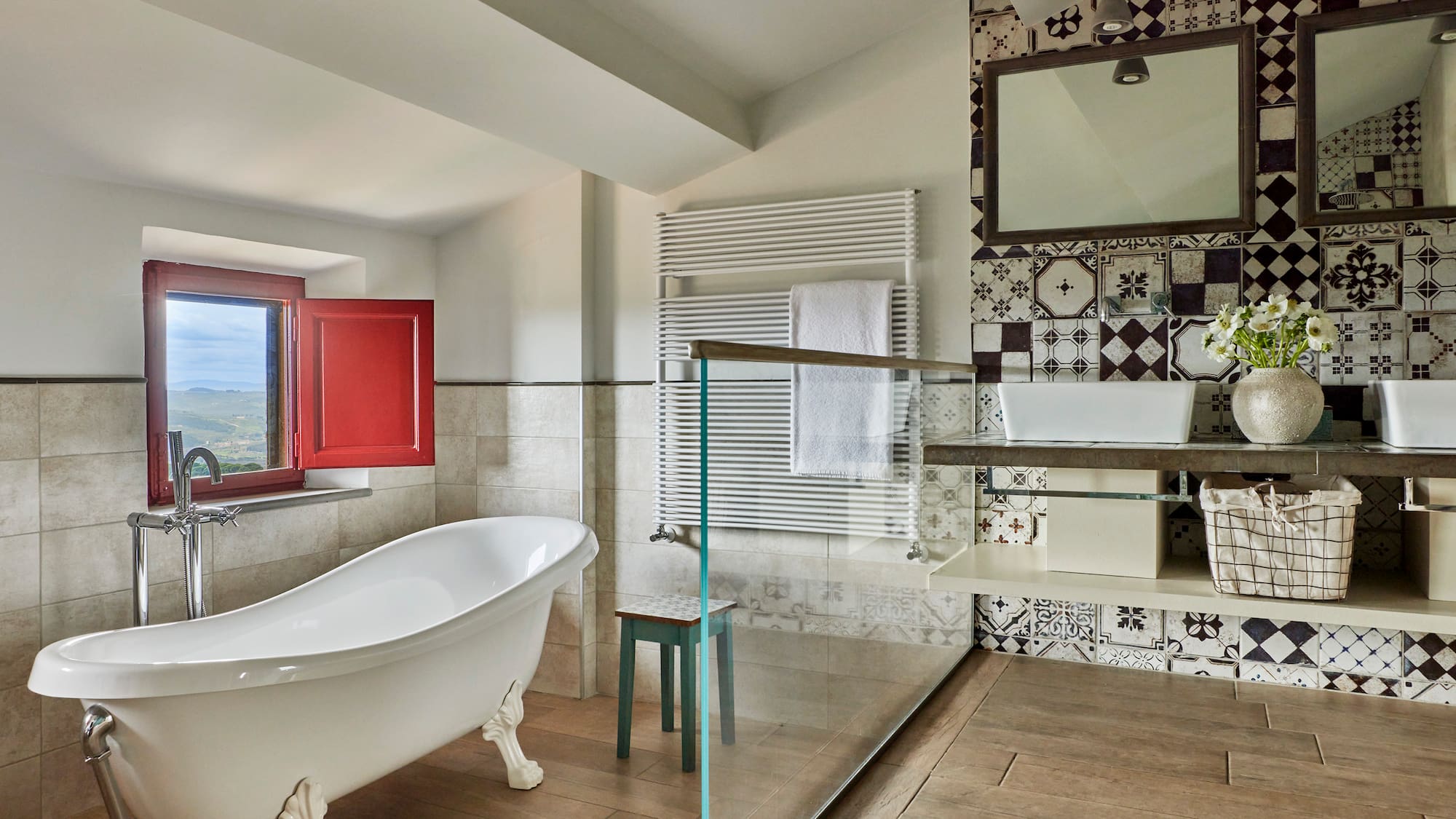 a bathroom with a glass shower and a tub