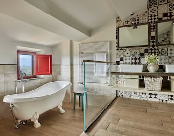 a bathroom with a glass shower and a tub