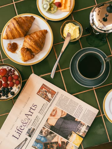 a breakfast with croissants and coffee