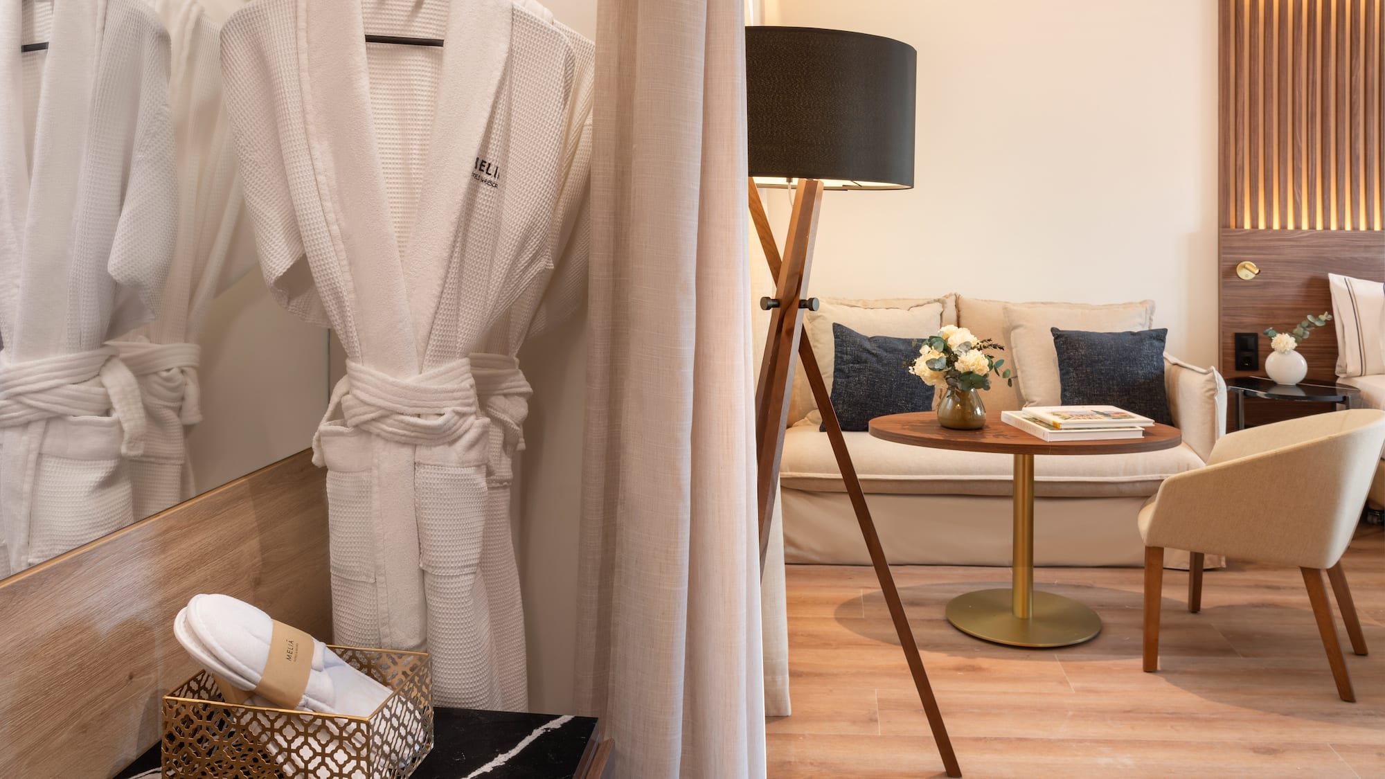 a room with a white robe and a table and a couch