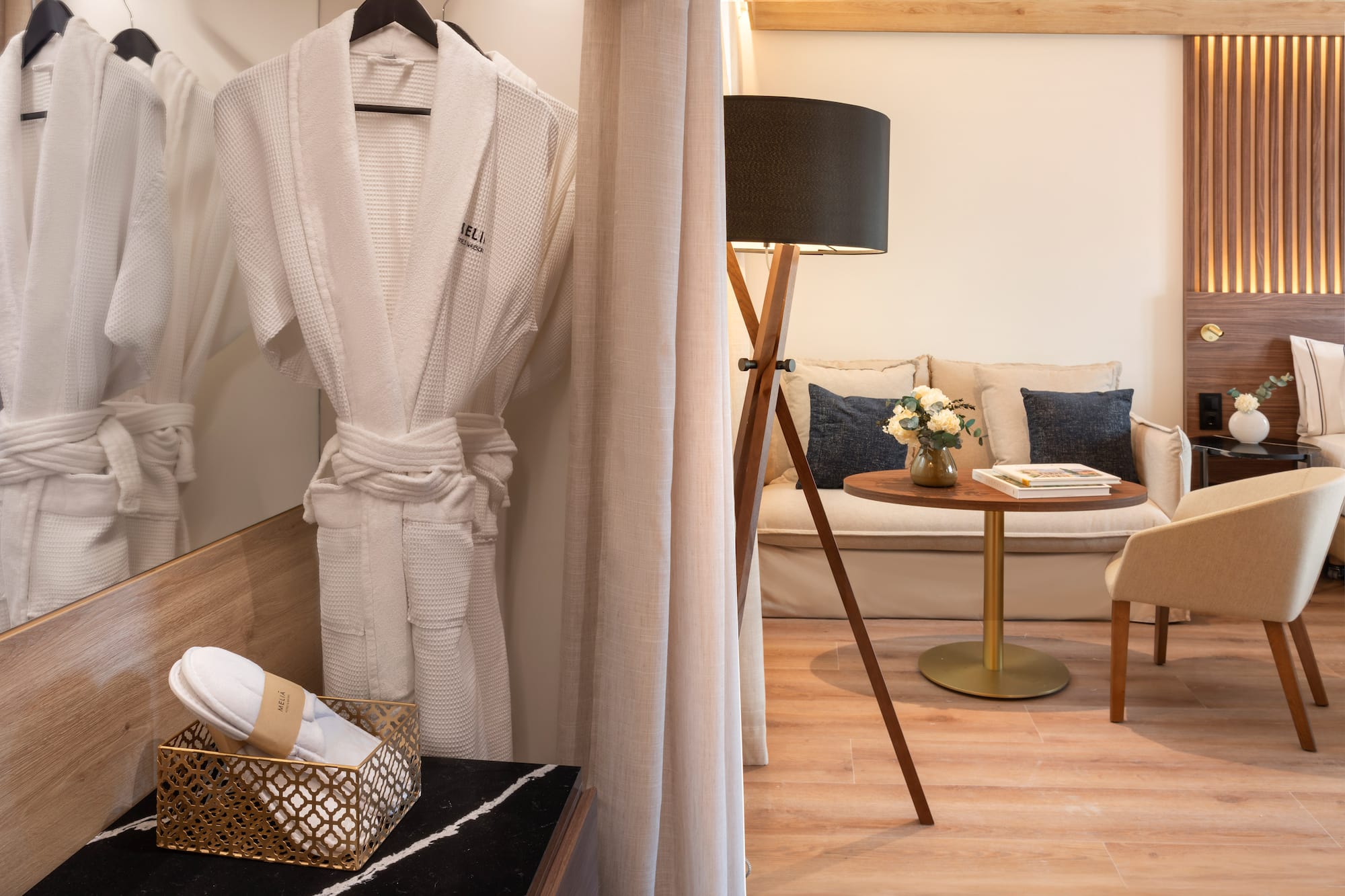 a room with a white robe and a table and a couch