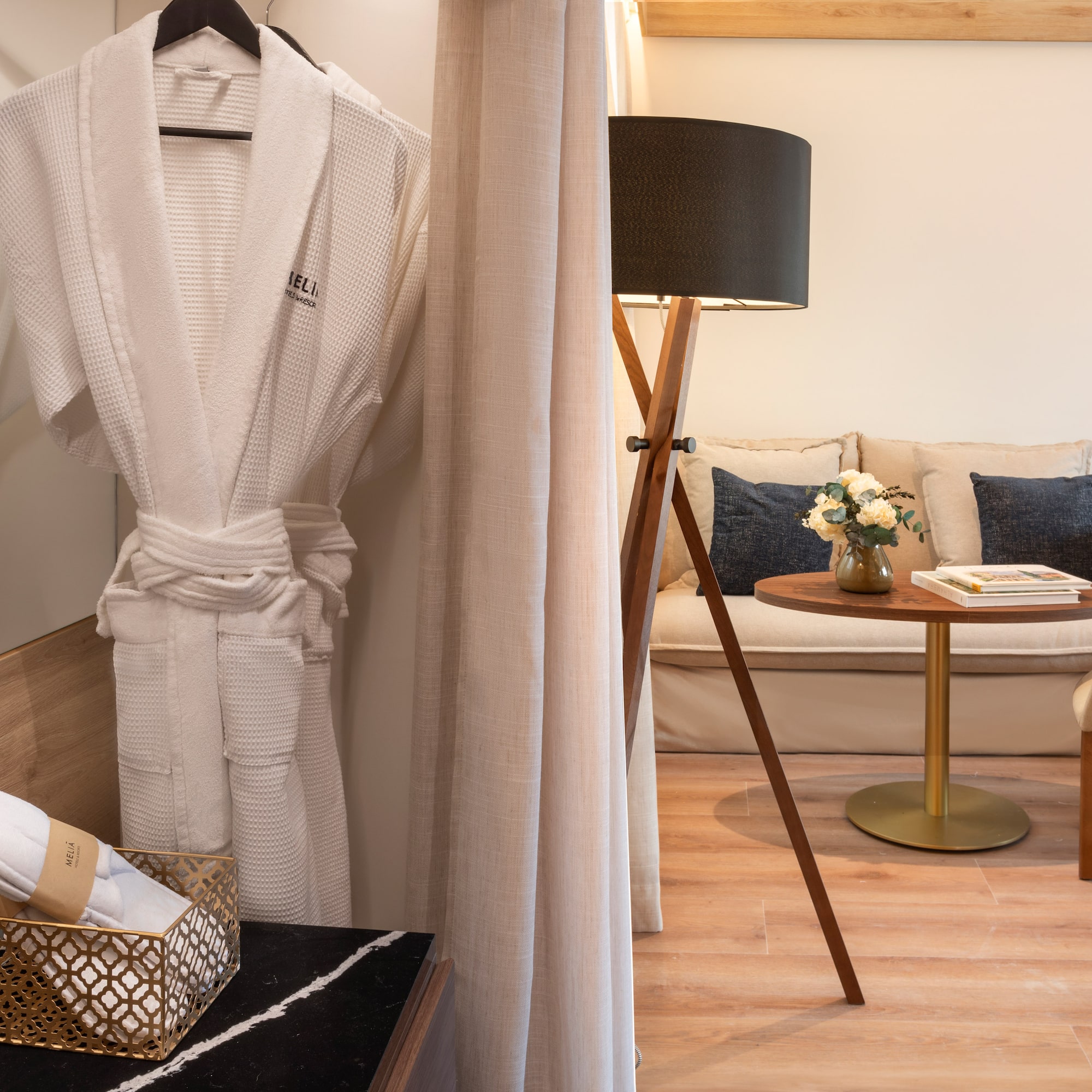 a room with a white robe and a table and a couch