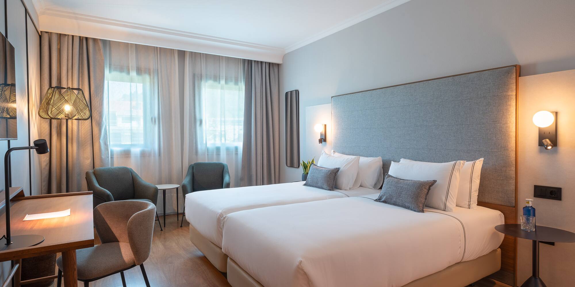 a hotel room with two beds and chairs