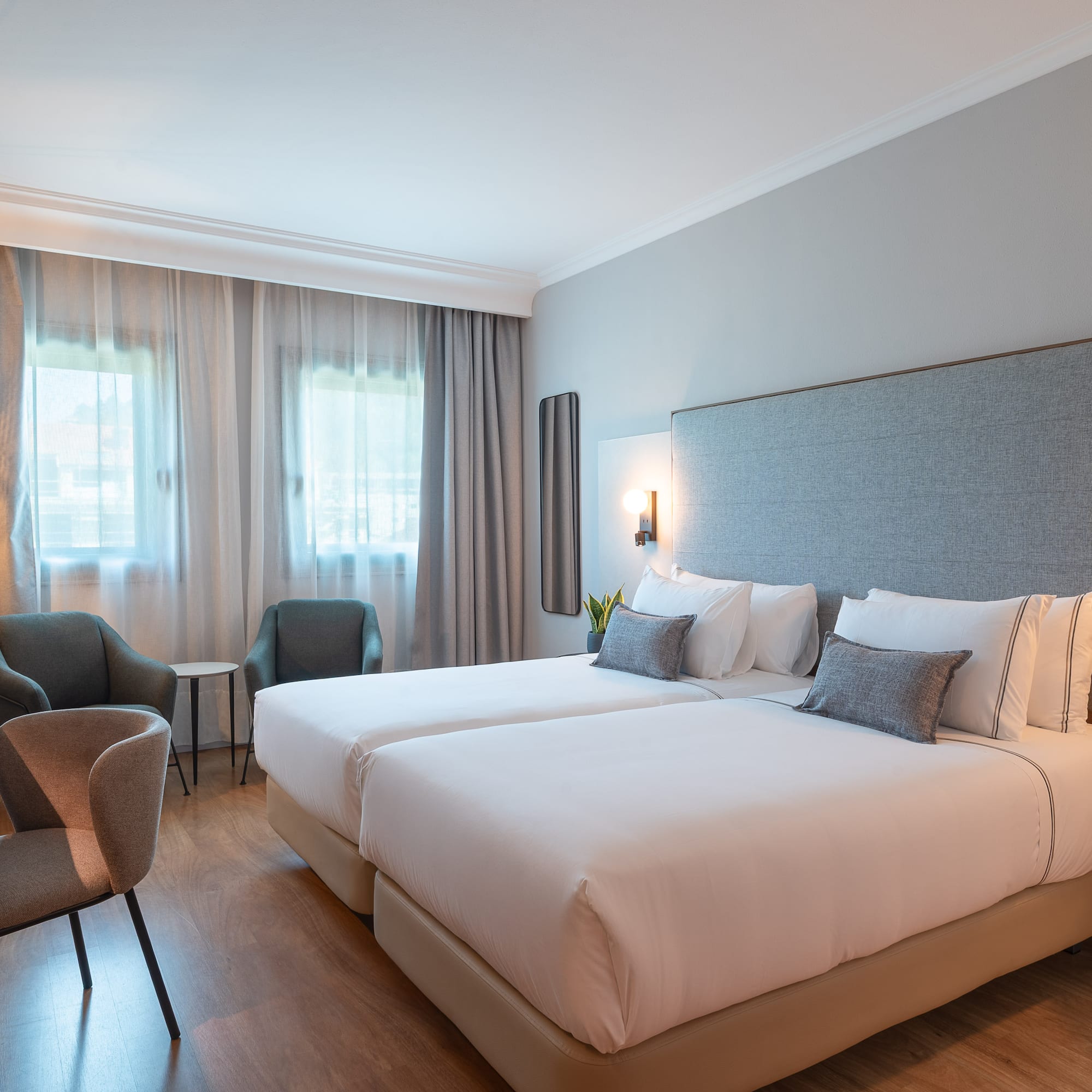 a hotel room with two beds and chairs