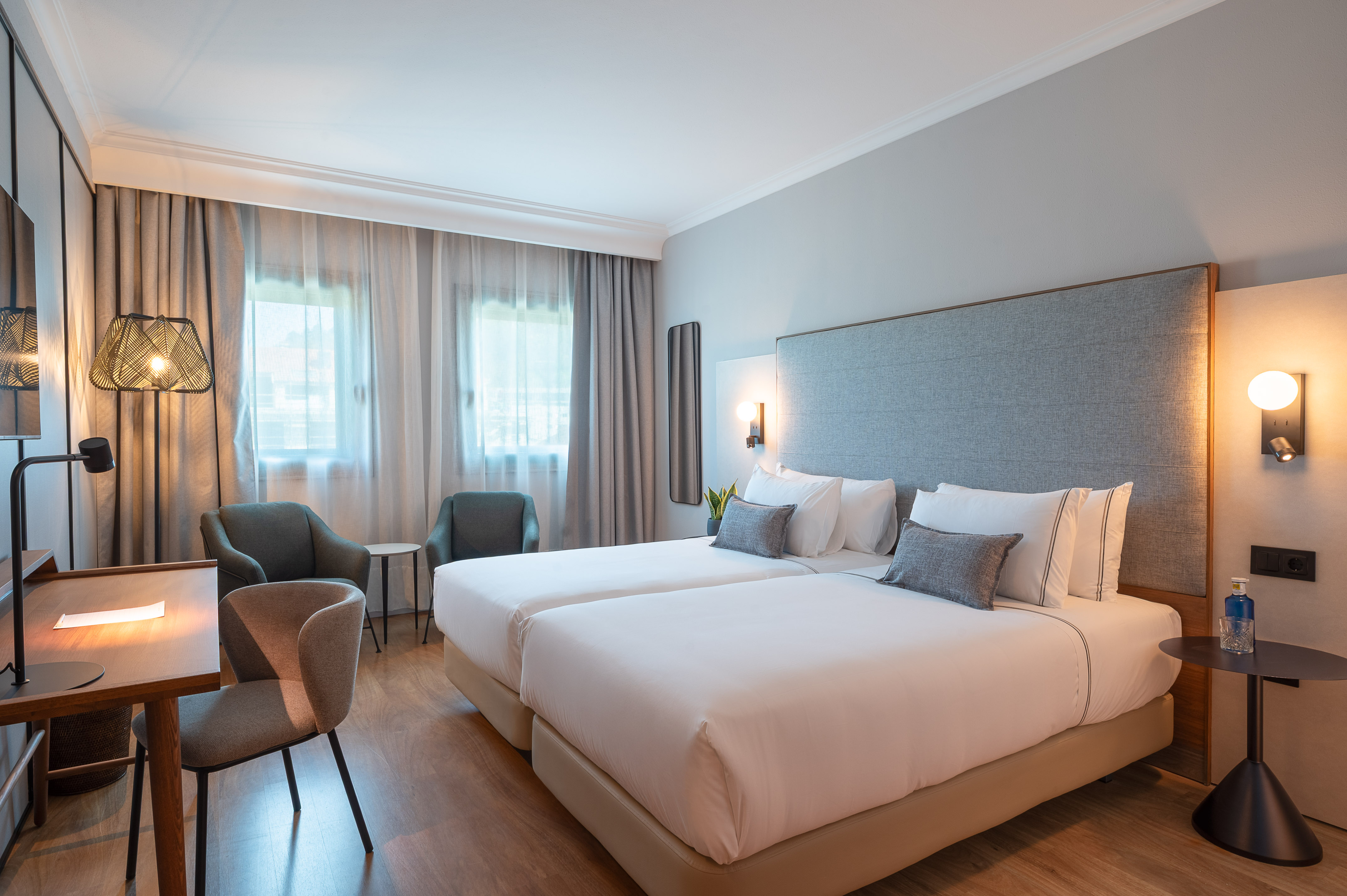 a hotel room with two beds and chairs