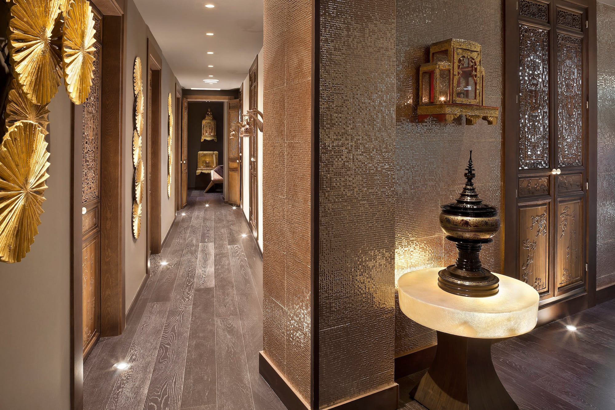 a hallway with a table and a mirror wall