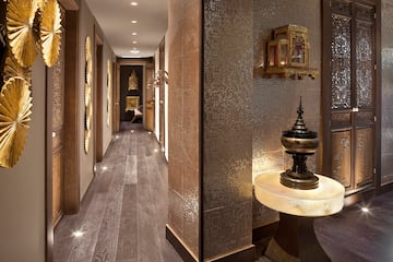 a hallway with a table and a mirror wall