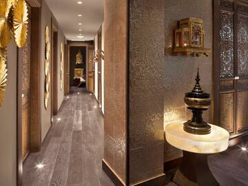 a hallway with a table and a mirror wall