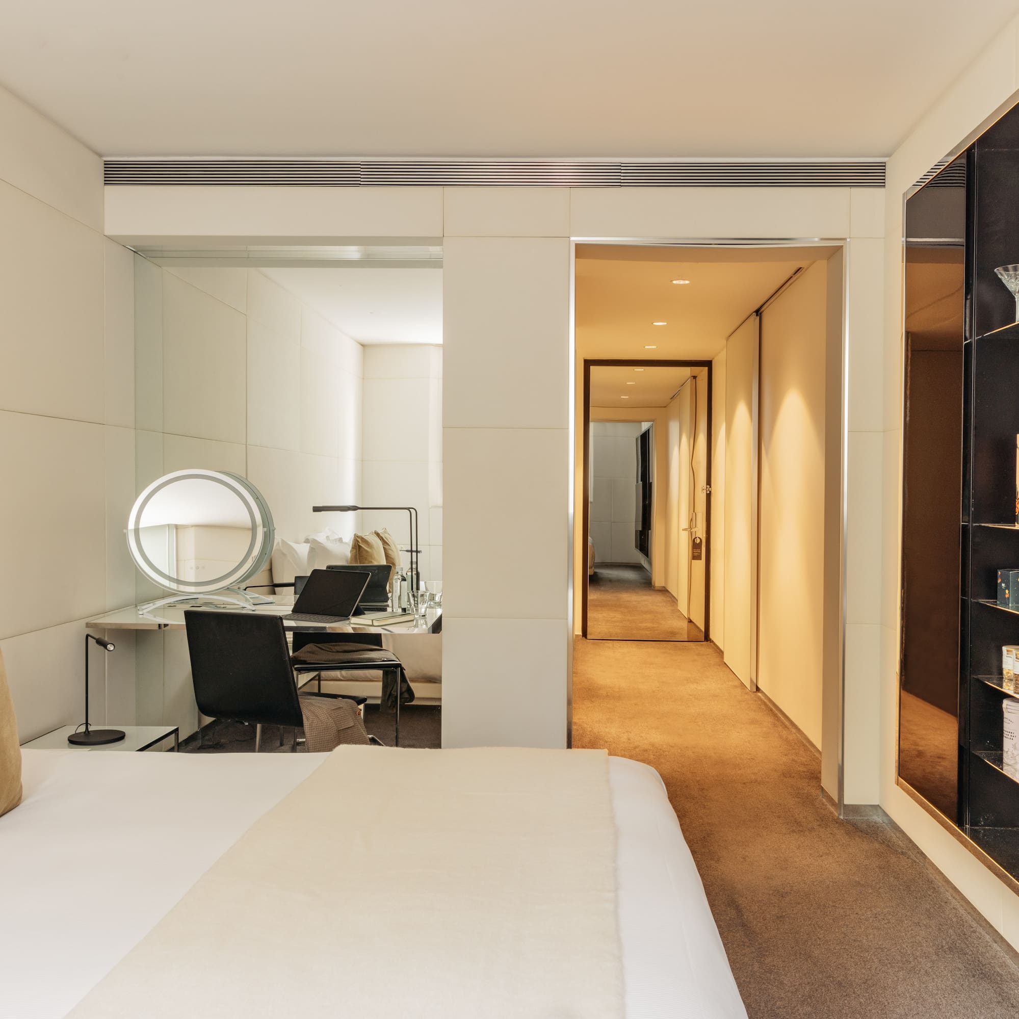 a bedroom with a mirror and a bed