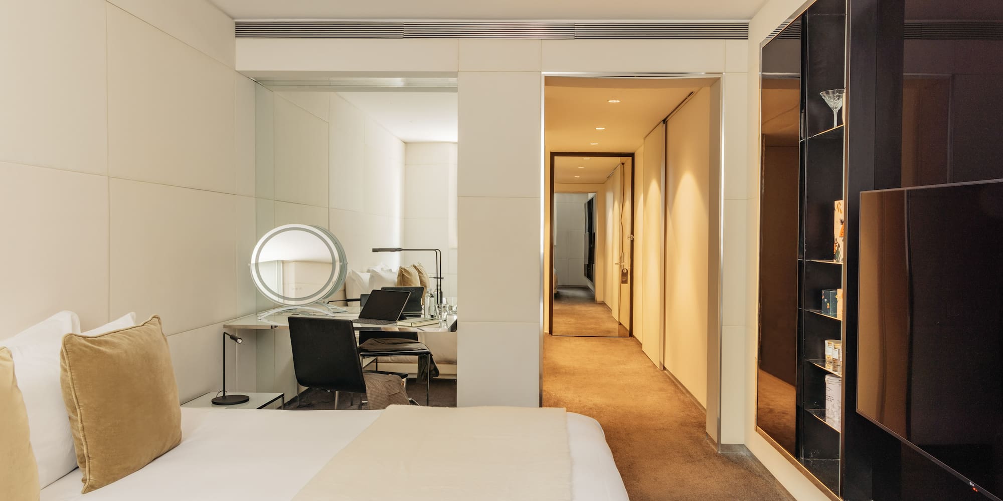 a bedroom with a mirror and a bed