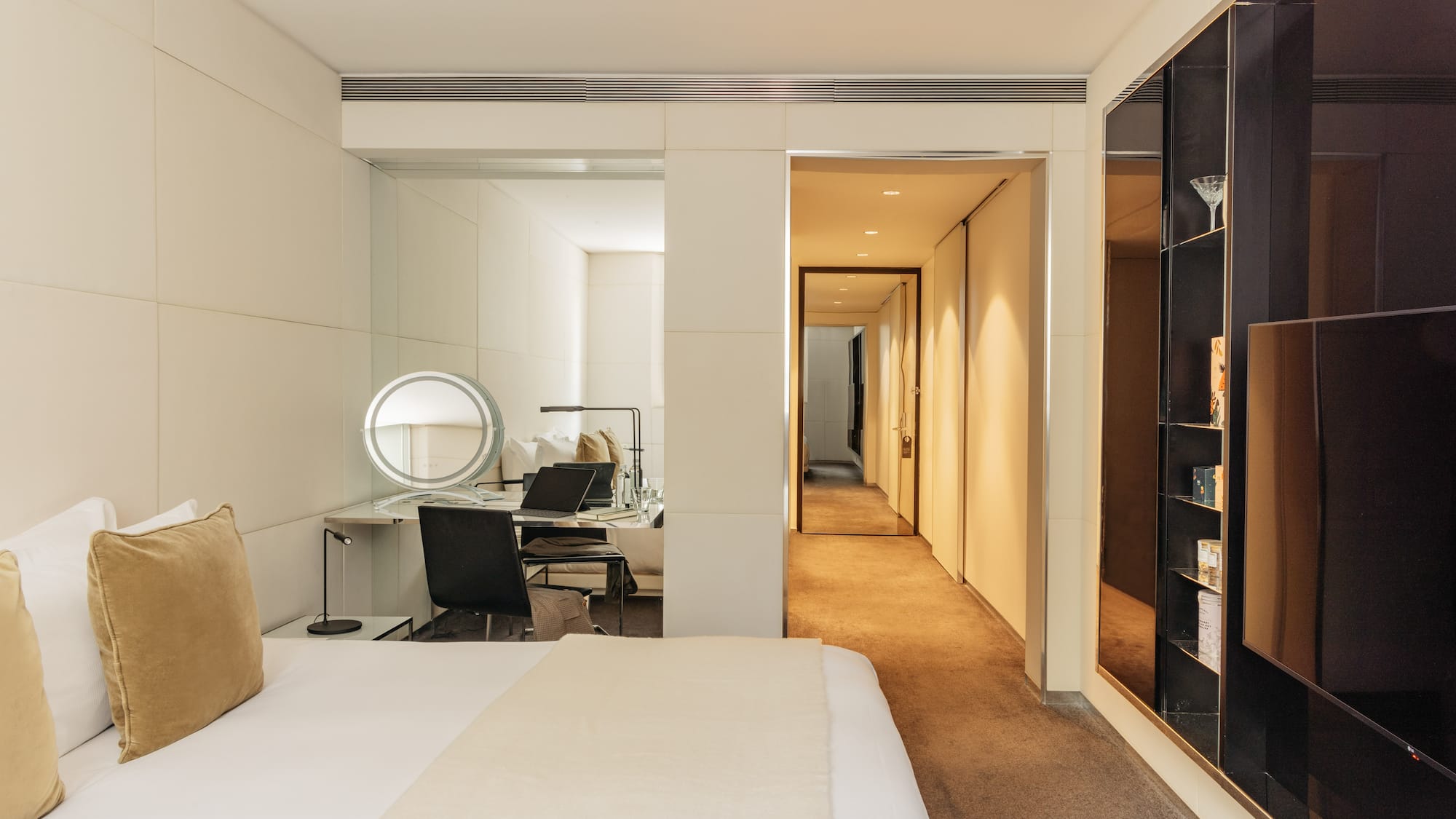 a bedroom with a mirror and a bed