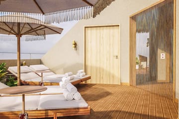 a deck with chairs and umbrellas