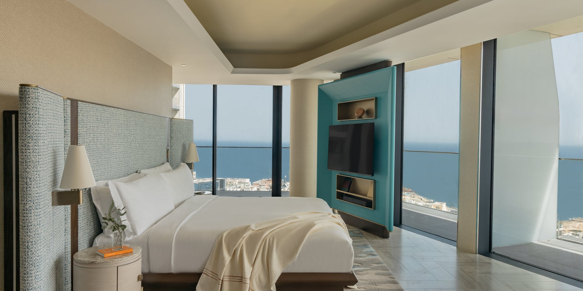 Spacious luxury bedroom with ocean views, king bed, and modern decor.