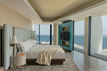a bedroom with a large television and a large window