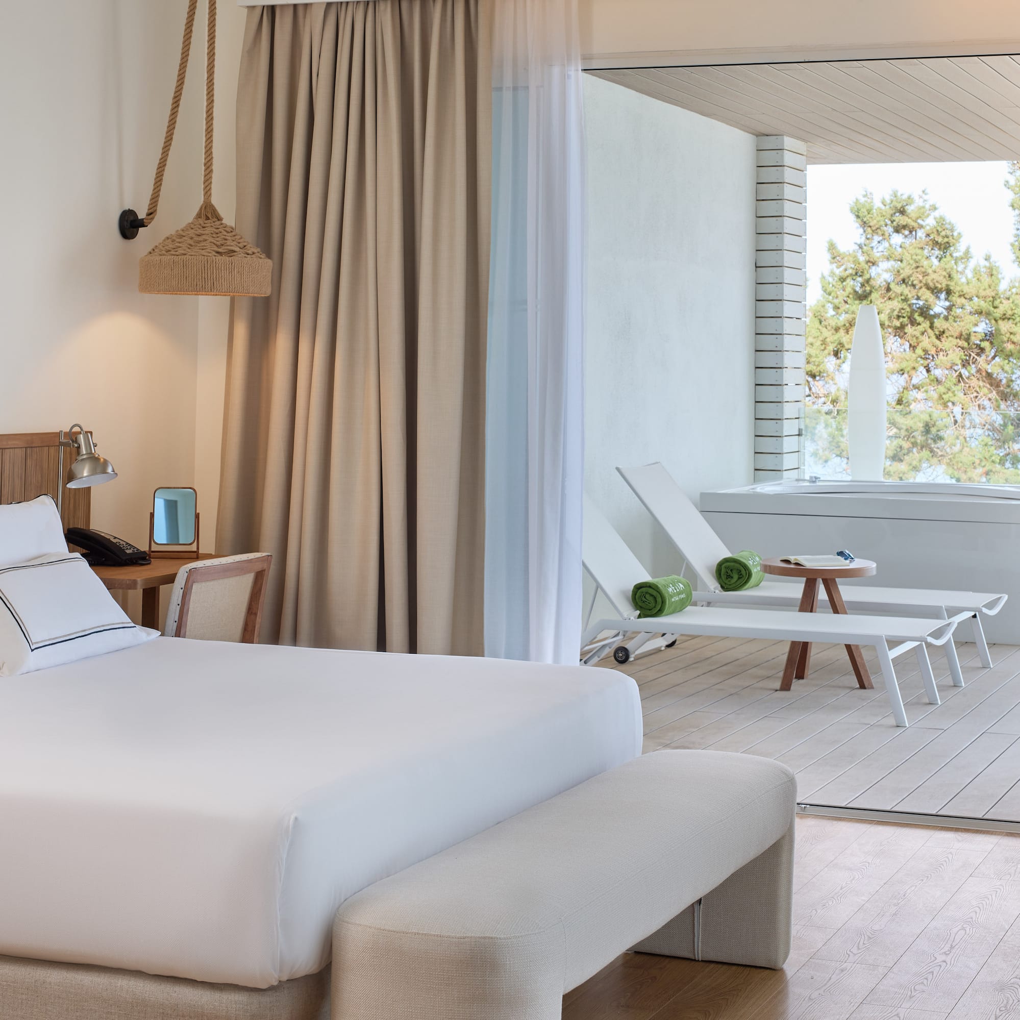 a room with a bed and chairs