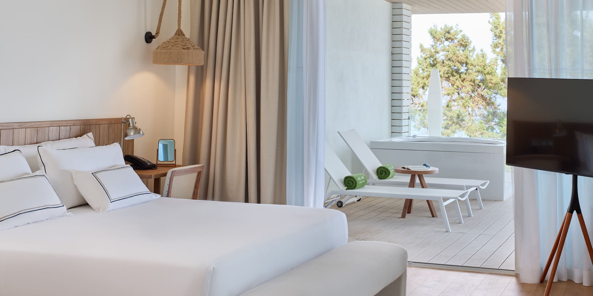 a room with a bed and chairs