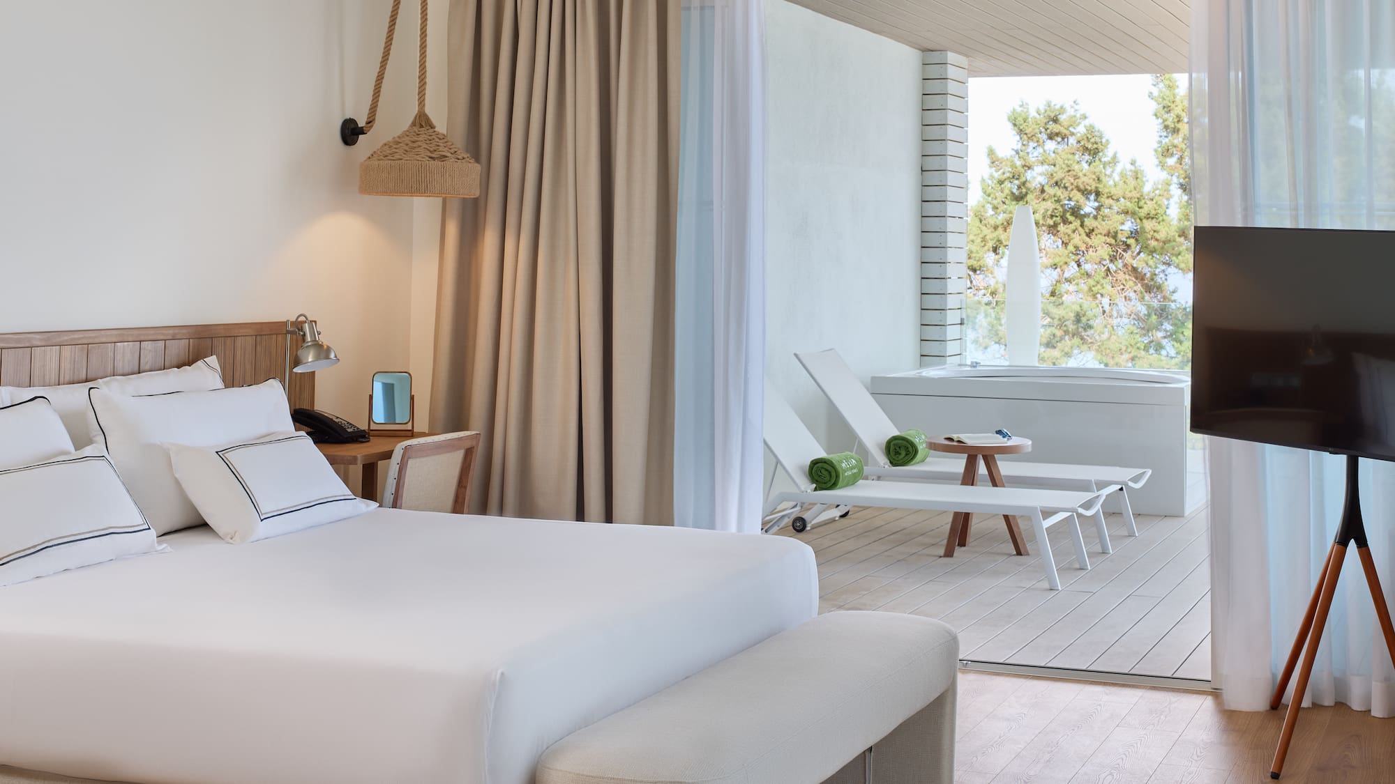 a room with a bed and chairs