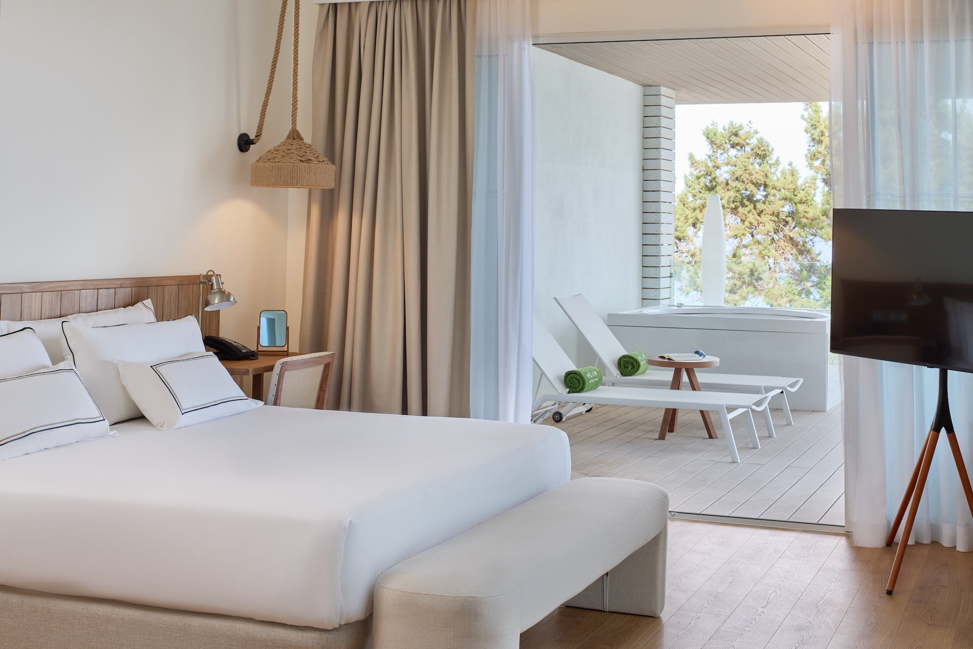 a room with a bed and chairs