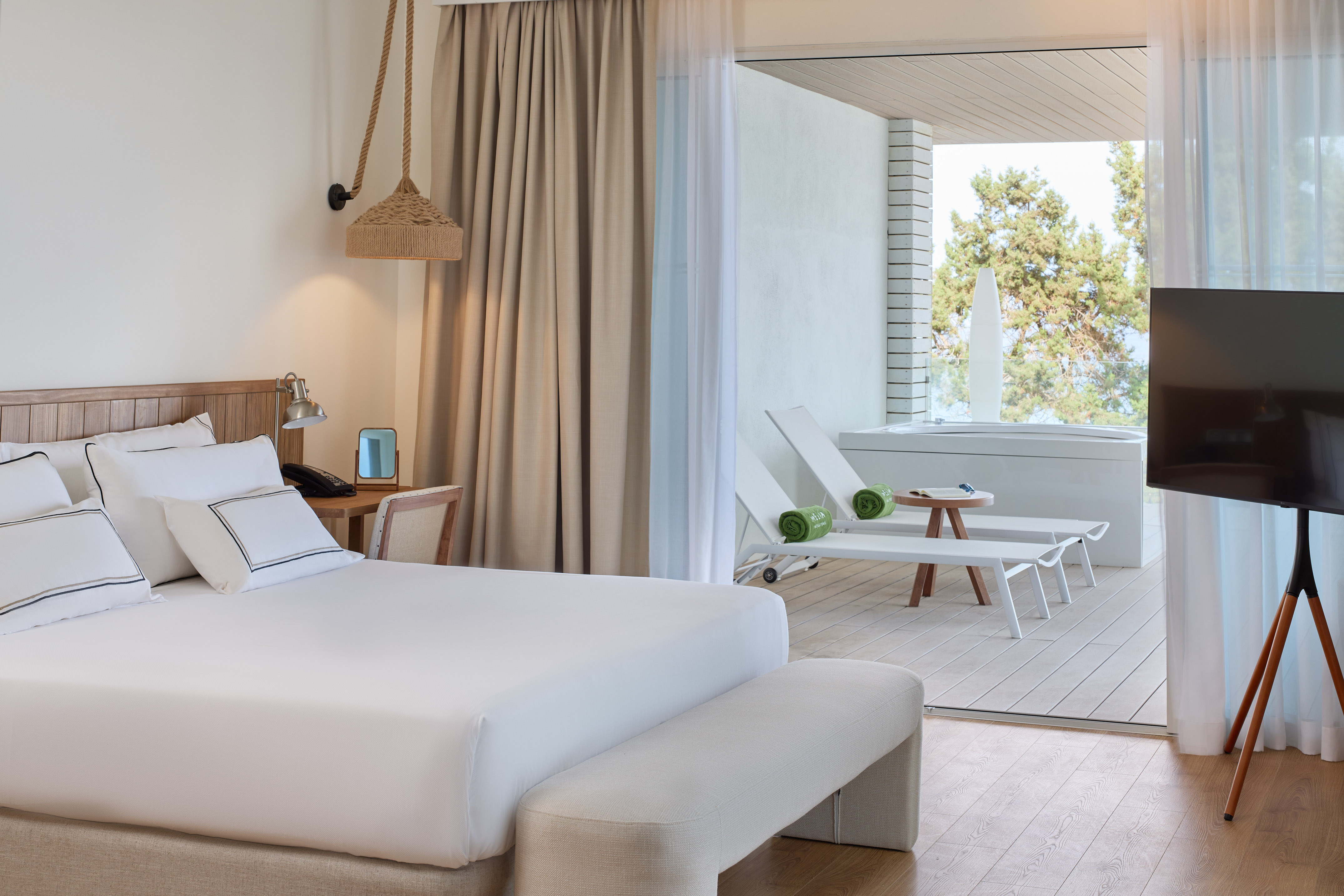 a room with a bed and chairs