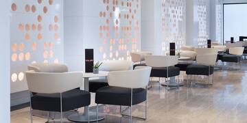 a room with white and black chairs and tables