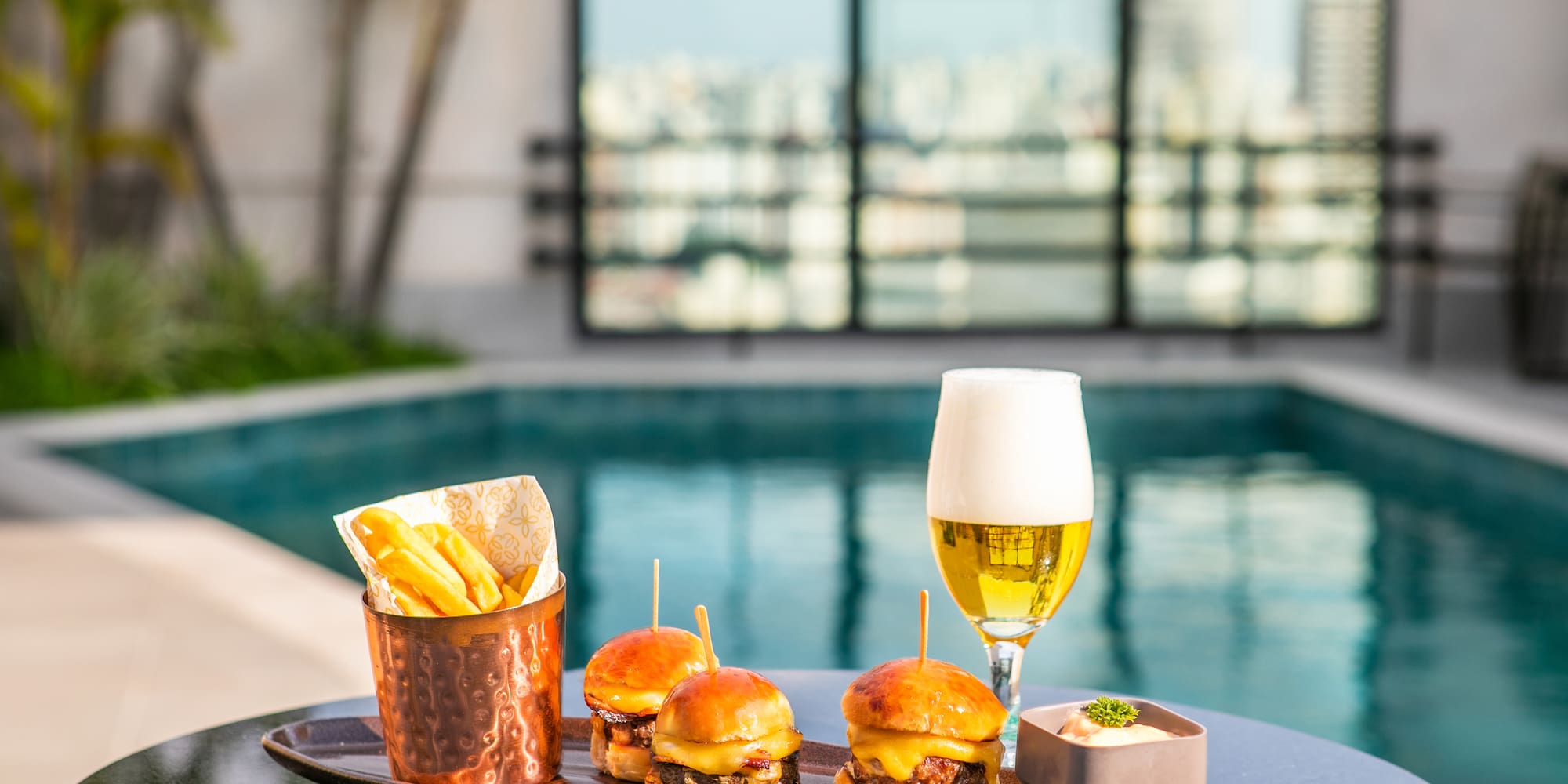 a plate of food and a glass of beer on a table
