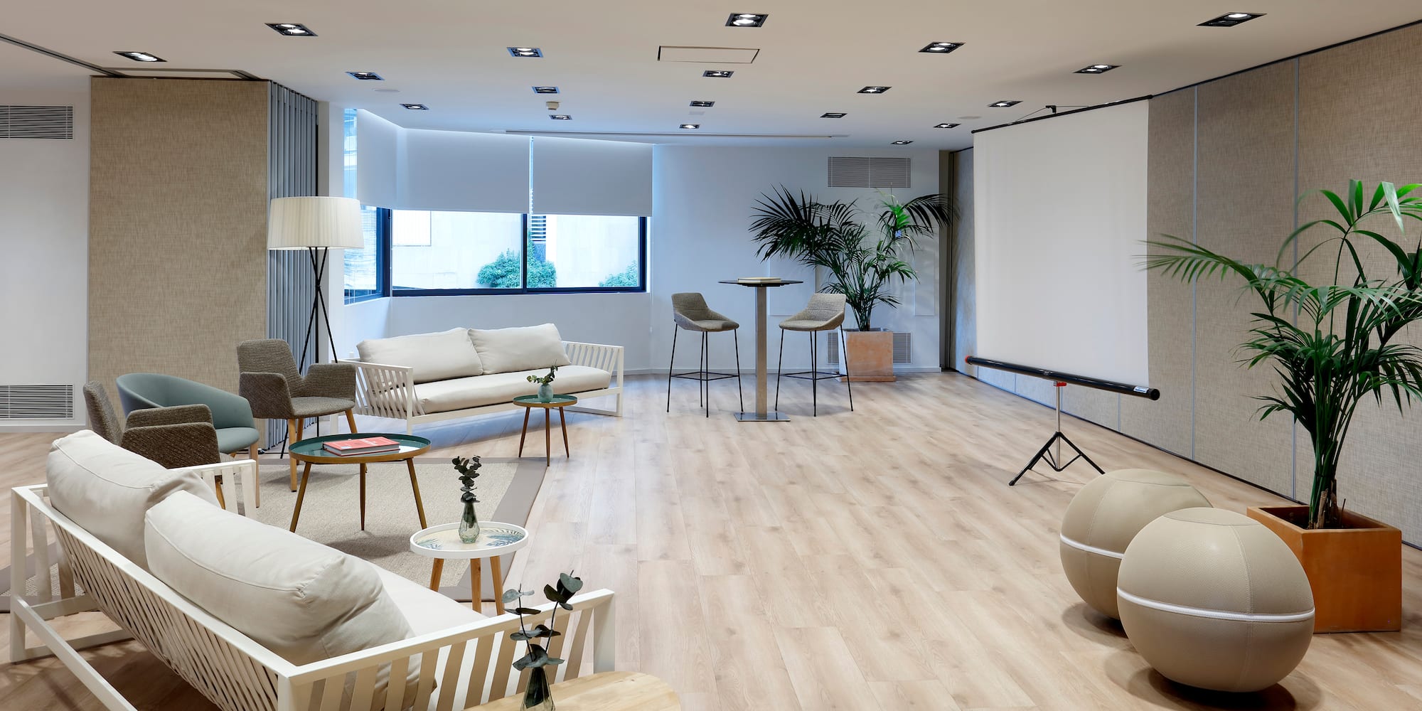 a room with a projector screen and chairs