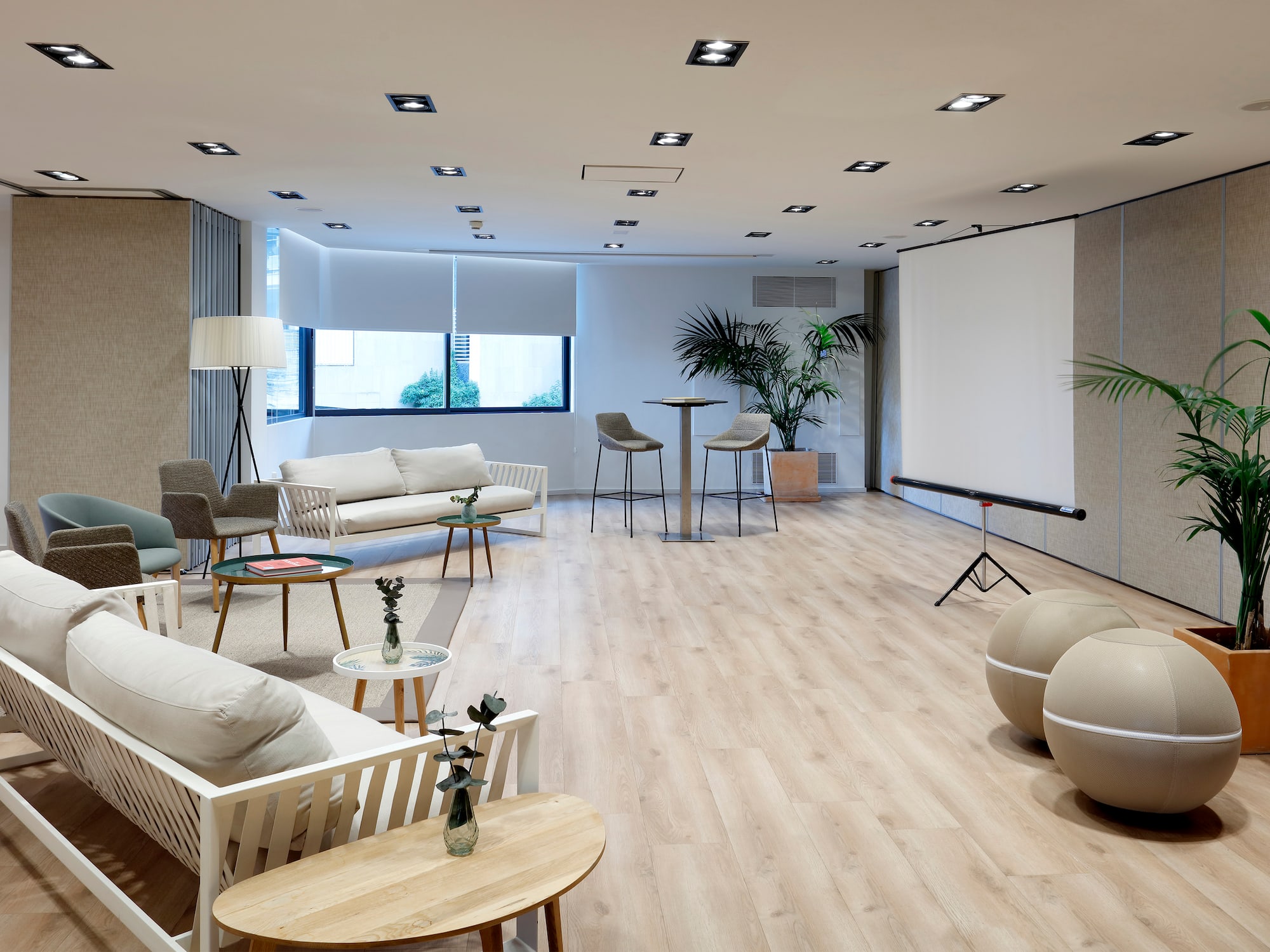 a room with a projector screen and chairs