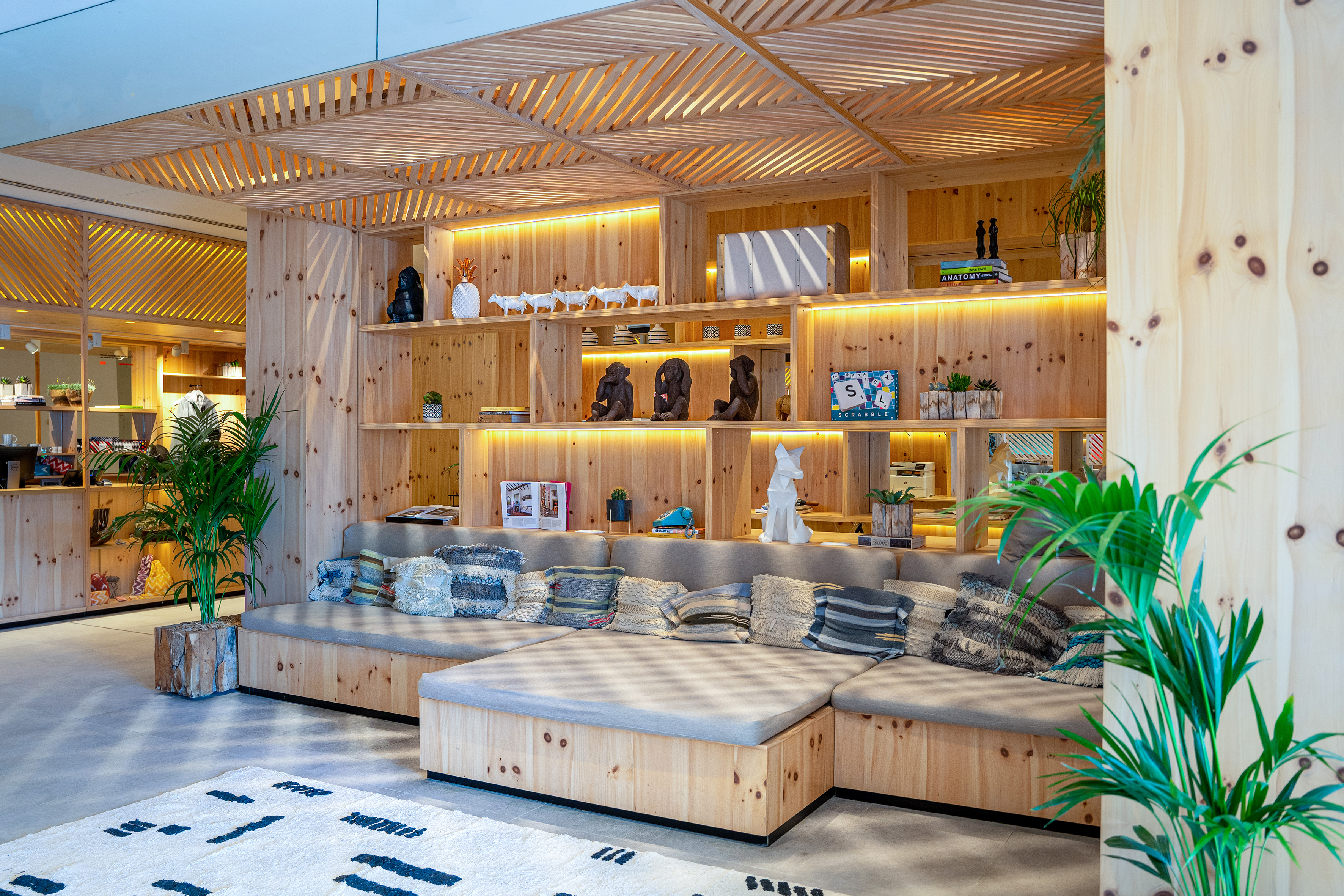 Cozy wooden lounge area with built-in shelving, seating, and decorative items.