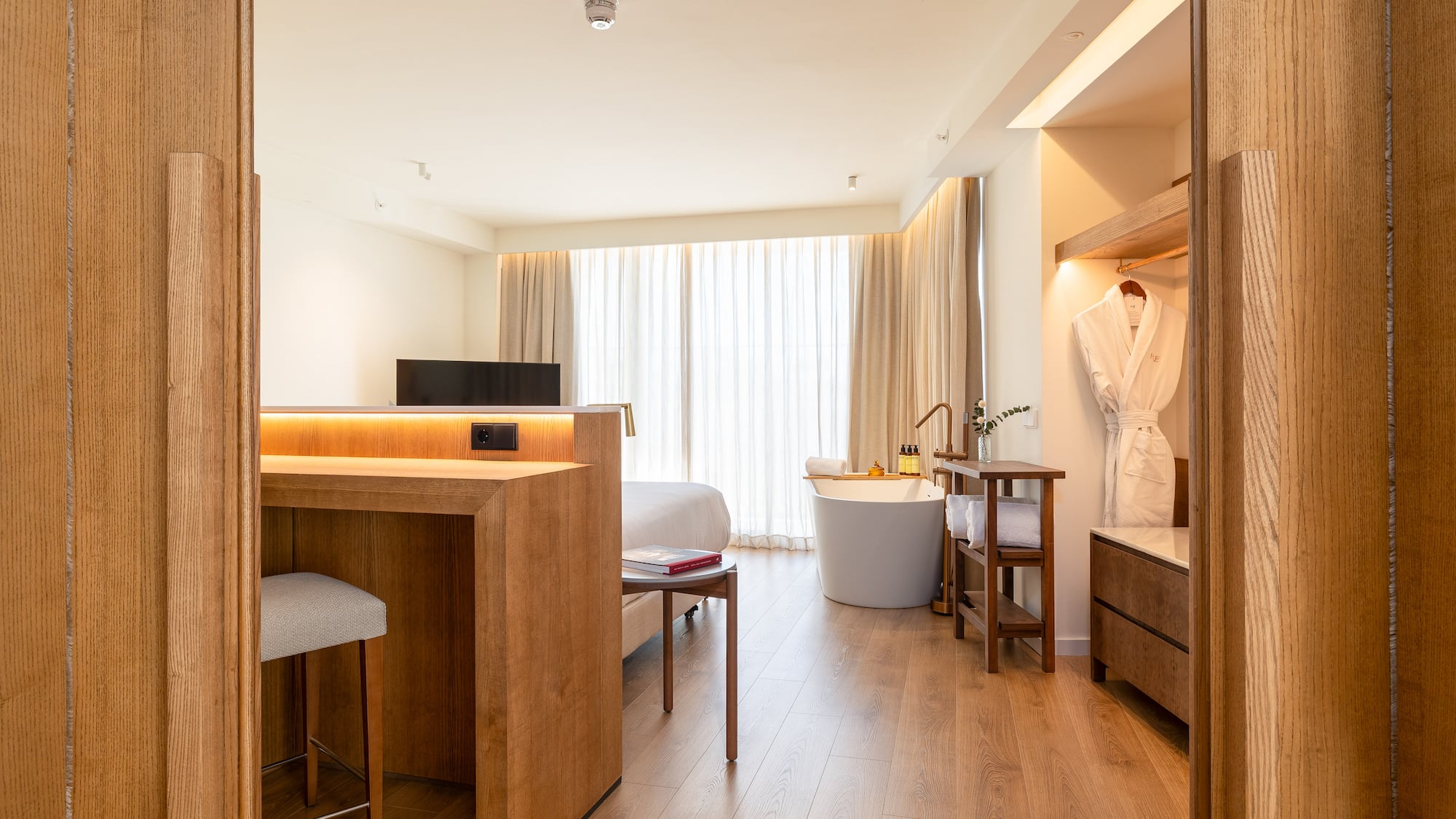 a room with a bed and a bathtub