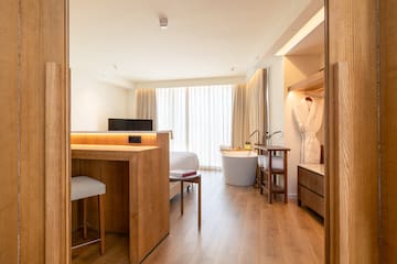 a room with a bed and a bathtub