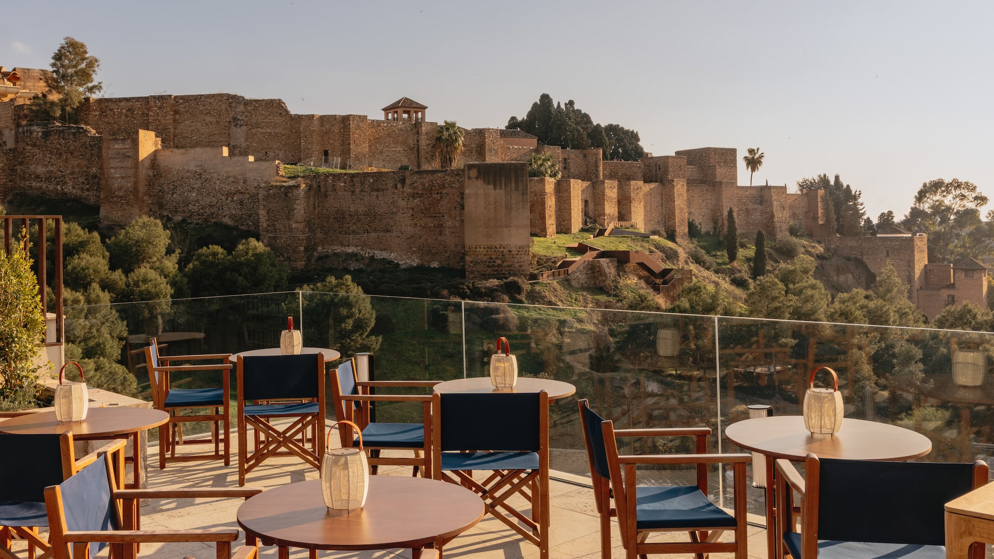 a table and chairs on a patio with a castle in the background